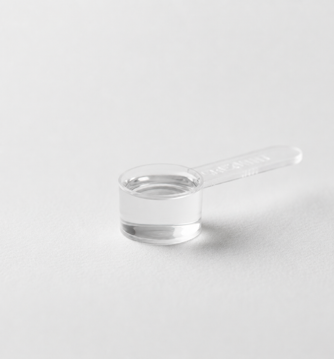 The same serve, as powder in a measuring scoop