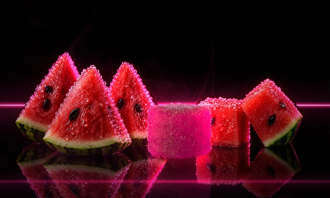 PUMP+ Sour Watermelon Blitz gummy beside sugared watermelon wedges